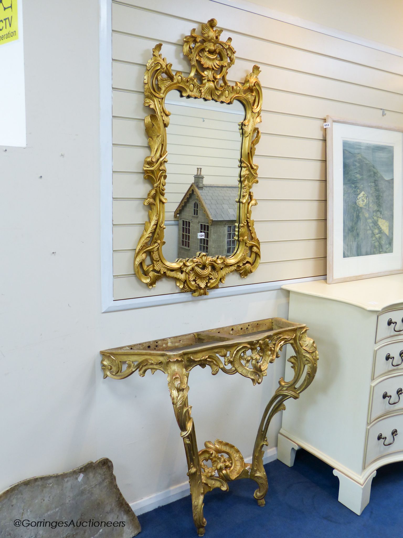 A 19th century rococo revival giltwood console table, 95cm wide, 86.5cm high and a similar later giltwood mirror, 113cm high, 64.5cm wide